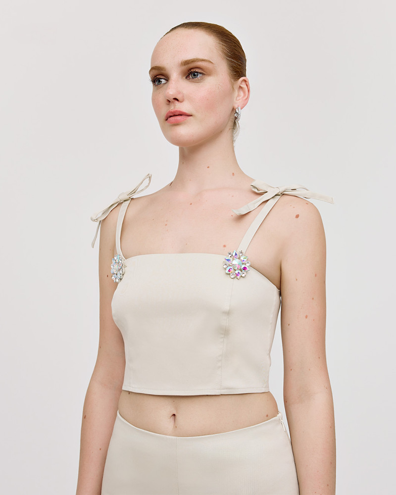 Bustier top with bows and brooches